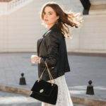 attractive woman walking in street in fashionable outfit